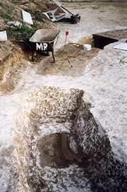 The grave cut on the west side of the causewayed ditch