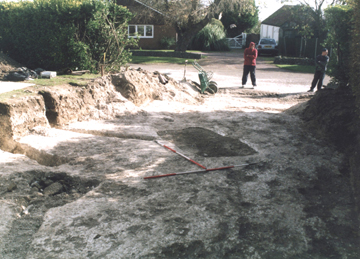 Two bodyguards keep an eye on the site while trying to remain inconspicuous