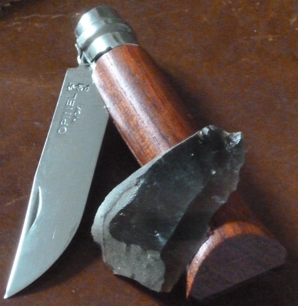 Image of a worked flint tool and its modern equivalent, a utility knife.