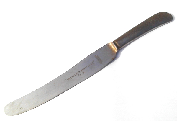 Image of a stainless steel dinner knife stamped Dreamland Margate Ltd 